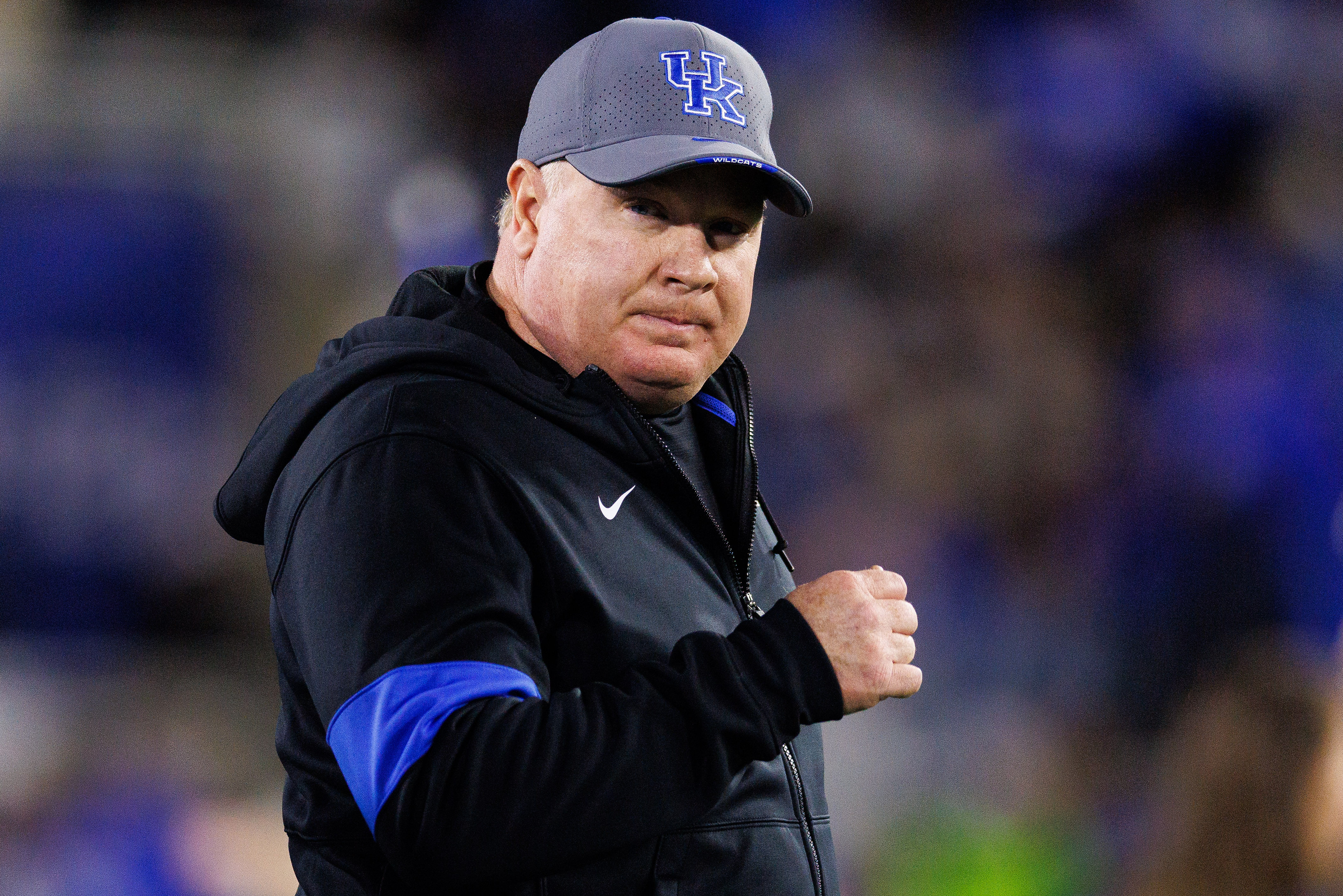 SEC coach Mark Stoops runs onto the field - Source: Imagn